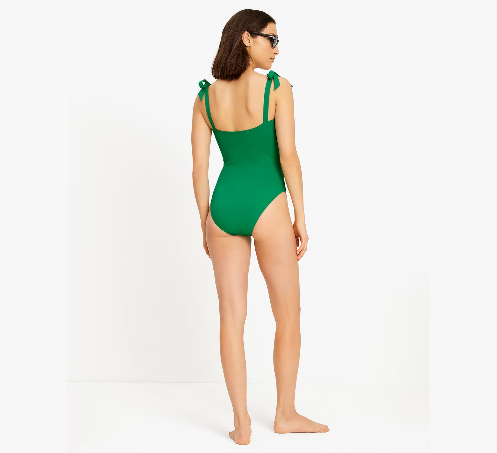 Kate Spade Solid Shird Square Neck Mio One Piece Swimsuit Shoulder bow tie detail Removable straps and soft cups Hand wash in cool water; Hang to dry 85% nylon, 15% spandex Product #: S98374 Back View